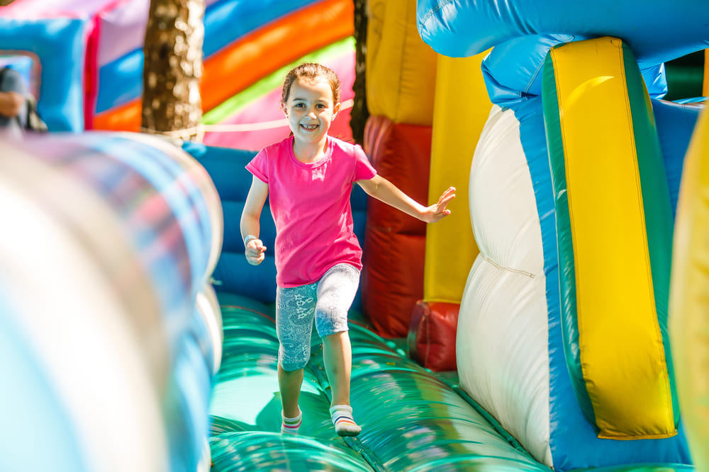 a child playing in a bouncy house