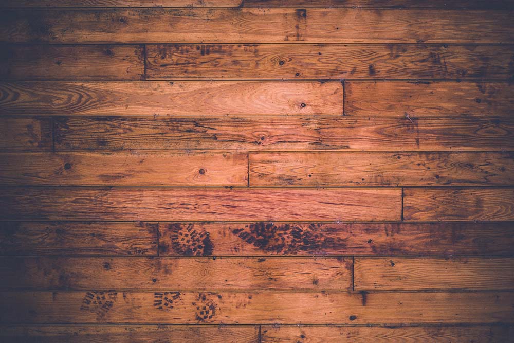 A birds-eye shot of hardwood floors with shoe-prints