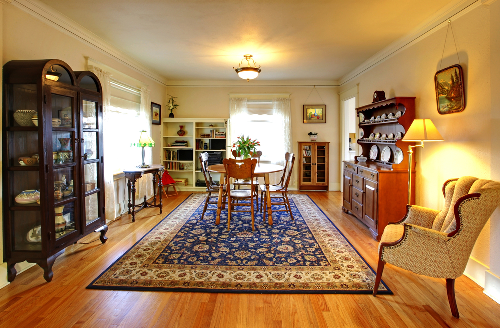 a blue patterned area rug in a dining room with a table and chairs on it