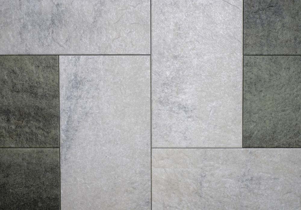 Gray and dark gray tiles of varying sizes in a geometric arrangement.