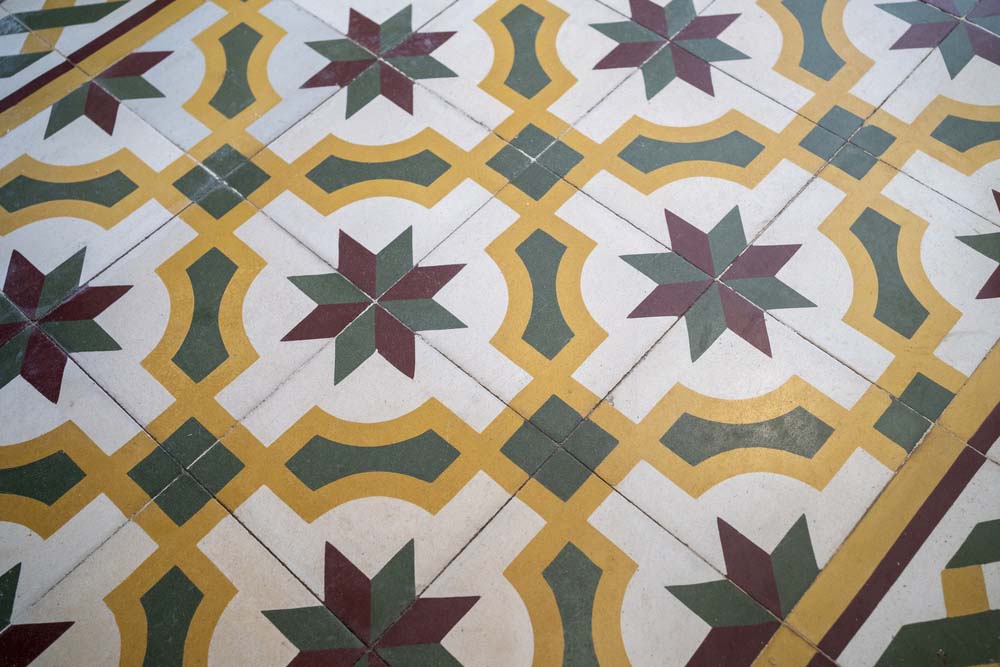 Vintage tiles that display a pattern of white, red, yellow, and green.